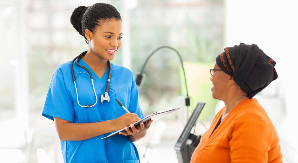 doctor in blue scrubs talking with woman
