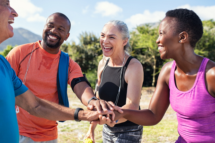 Group of friends in a huddle before sports event